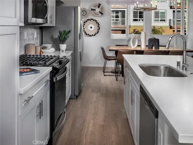 a kitchen with stainless steel appliances granite countertop a stove and a sink