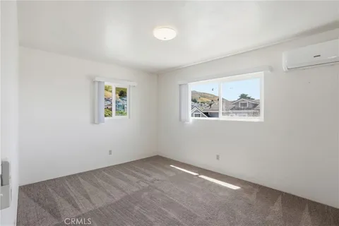 an empty room with a painting on the wall