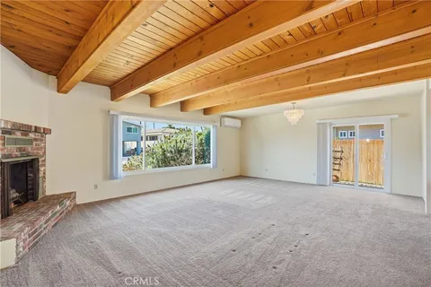 a view of empty room with a fireplace