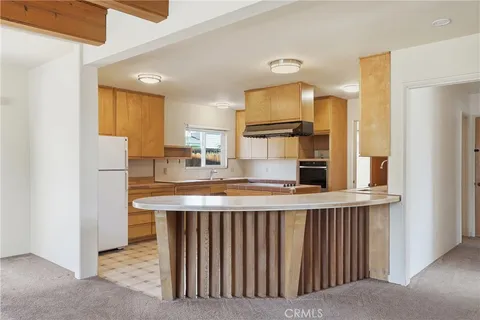 a kitchen with stainless steel appliances granite countertop a sink and a refrigerator
