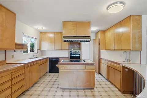 a kitchen with a sink stove and cabinets