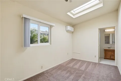 an empty room with a window and a ceiling fan