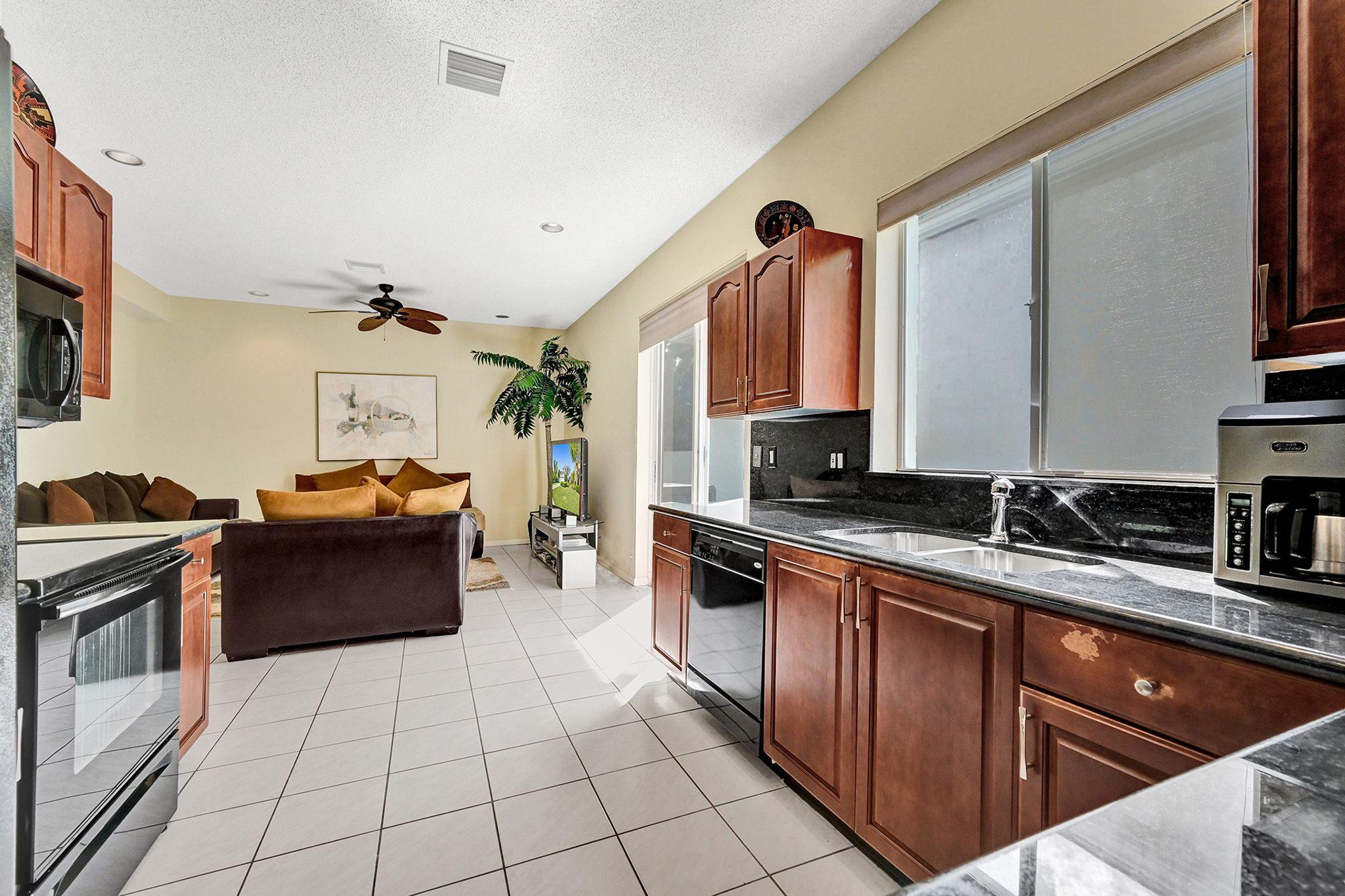 7892 Travelers Tree Drive Boca Raton, FL 33433 - Photo 14 of 42 Kitchen and Family Room