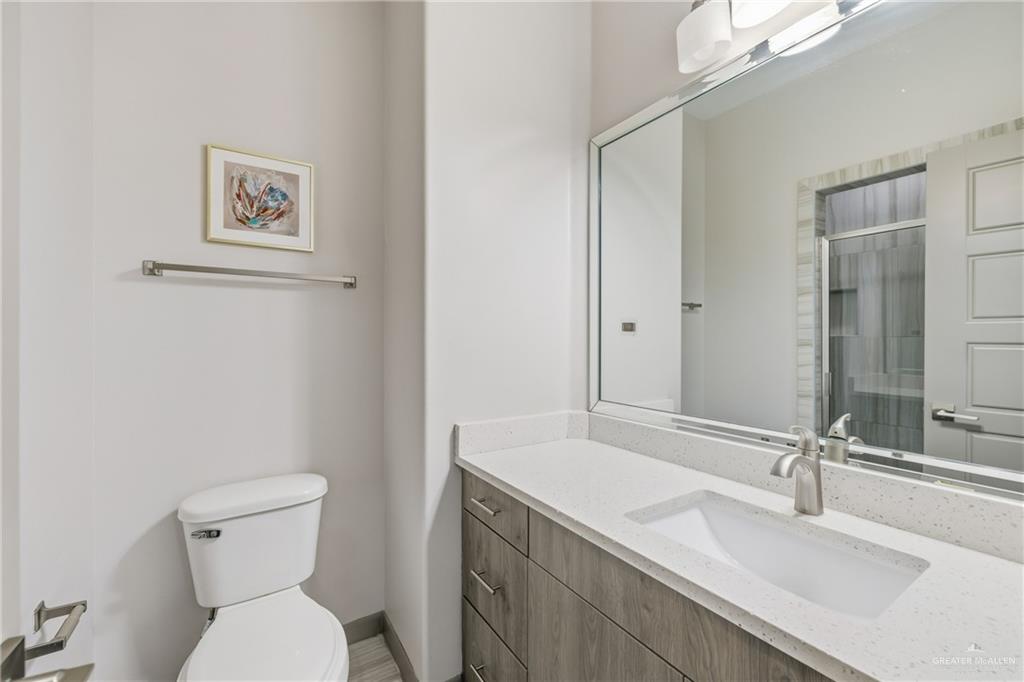 3302 South Sugar Road, Unit H Edinburg, TX 78539 - Photo 15 of 24 a bathroom with a sink vanity mirror and toilet