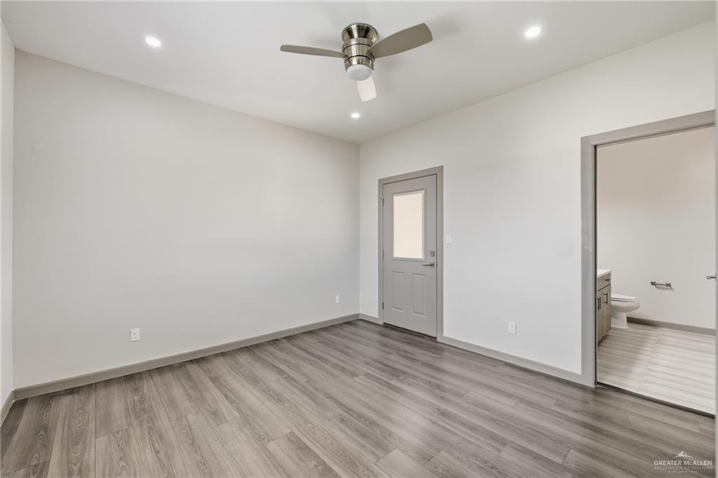 3302 South Sugar Road, Unit H Edinburg, TX 78539 - Photo 17 of 24 wooden floor in an empty room with a window