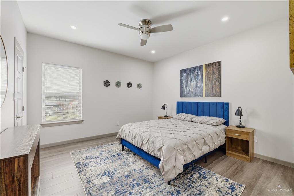 3302 South Sugar Road, Unit H Edinburg, TX 78539 - Photo 9 of 24 a bedroom with a large bed and a chandelier