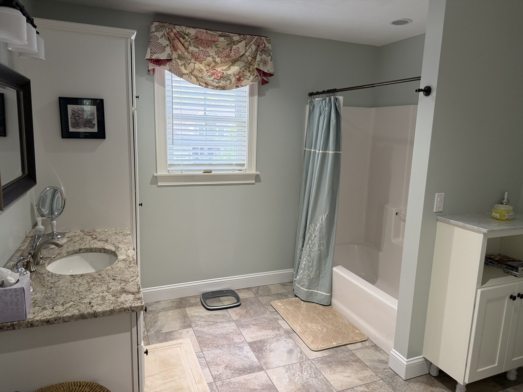 4 Tamarack Lane Sandwich, MA 02563 - Photo 25 of 42 a bathroom with a granite countertop sink and a mirror