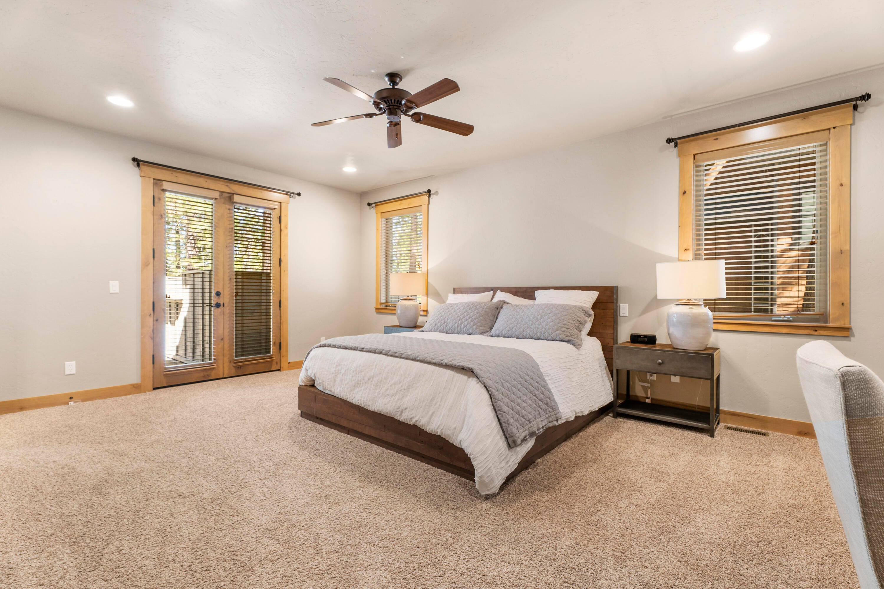 56431 Fireglass Loop, Unit 191 Bend, OR 97707 - Photo 20 of 50 The main level hosts the primary suite, complete with a generous bathroom featuring a soaking tub, a tile shower, and a large walk-in closet.