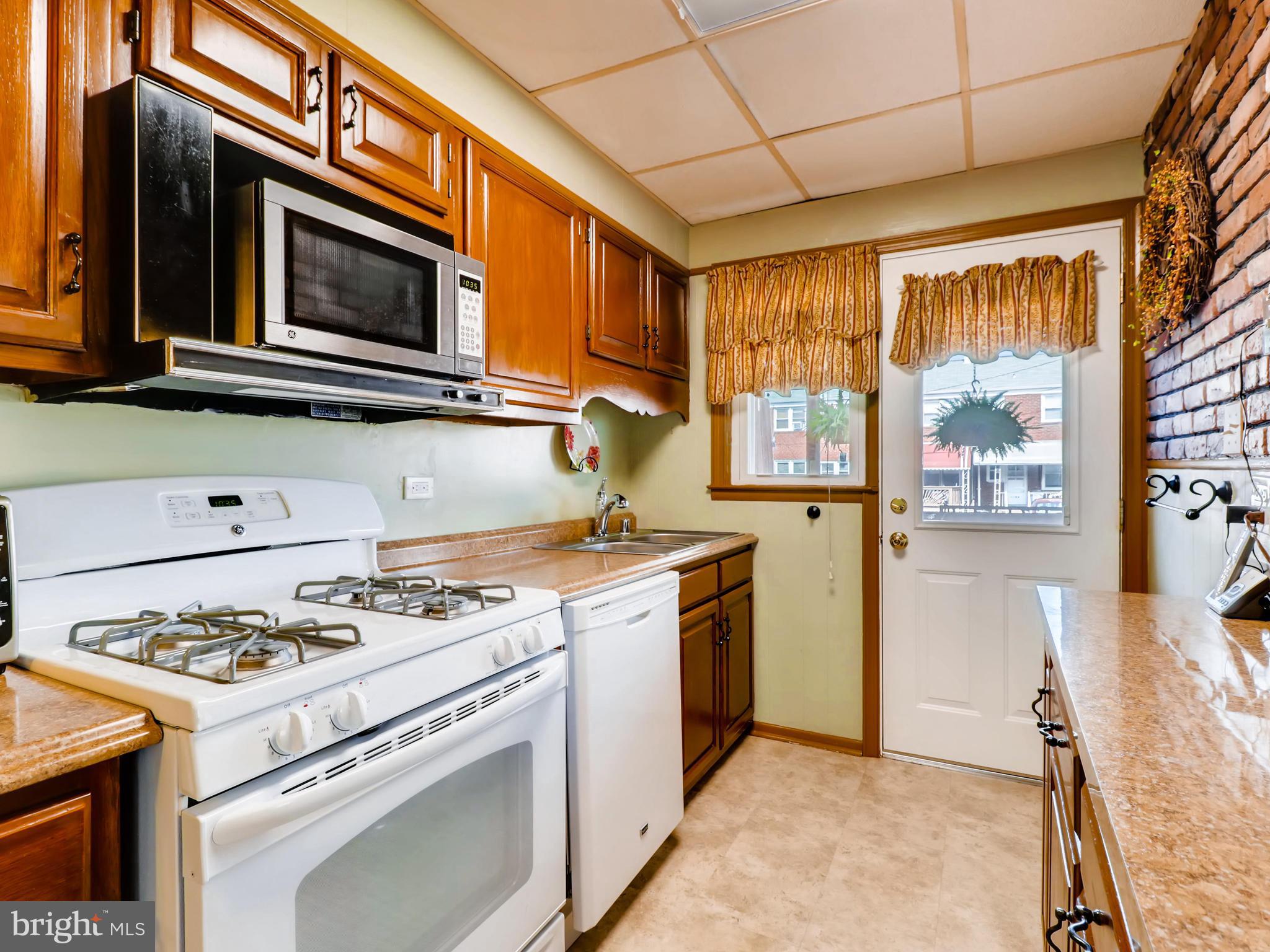 2207 Graythorn Road Baltimore, MD 21220 - Photo 14 of 30 a kitchen with a stove and a microwave