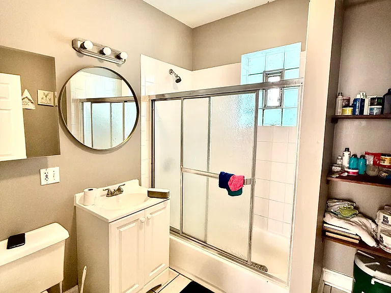 831 North Ashland Avenue, Unit 2 Chicago, IL 60642 - Photo 12 of 12 a bathroom with a sink and a mirror