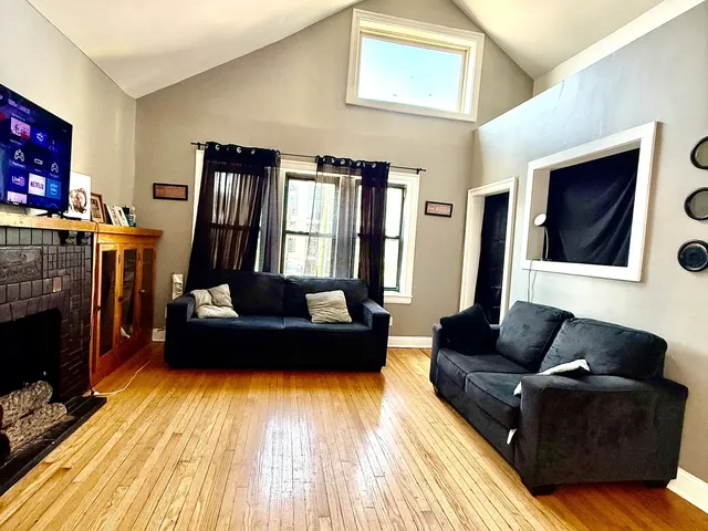 a living room with furniture and a fireplace