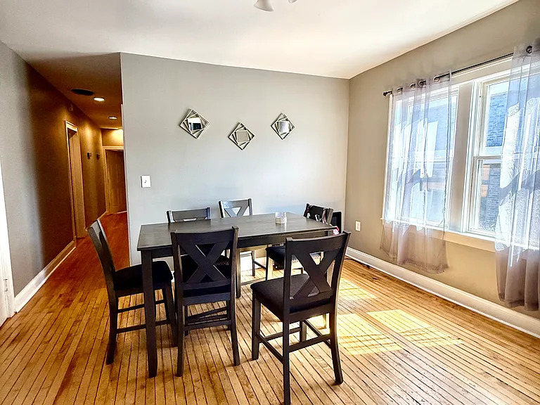 831 North Ashland Avenue, Unit 2 Chicago, IL 60642 - Photo 3 of 12 a view of a dining room with furniture and wooden floor