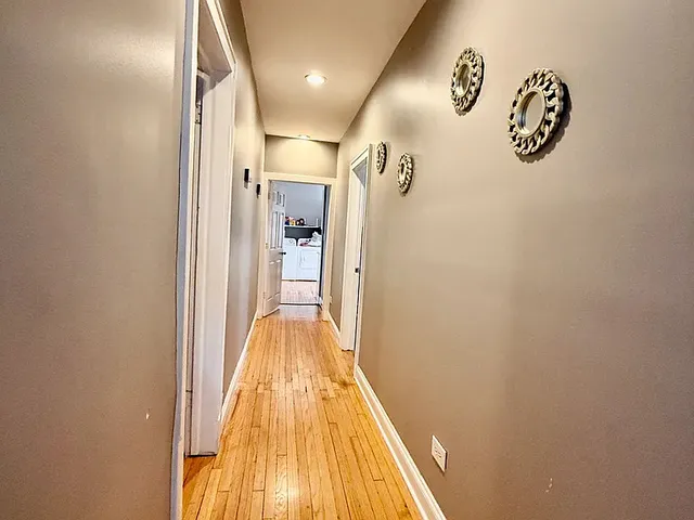 a view of a hallway with wooden floor