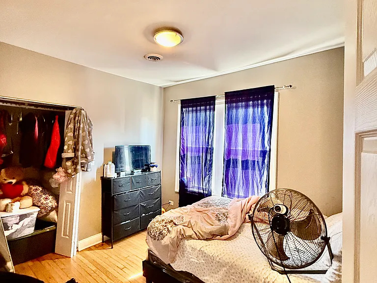 831 North Ashland Avenue, Unit 2 Chicago, IL 60642 - Photo 9 of 12 a bedroom with a bed and a television
