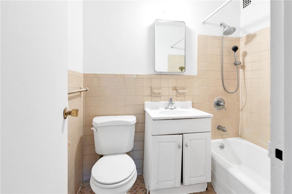 2930 West 5th Street, Unit 2C Brooklyn, NY 11224 - Photo 20 of 21 a bathroom with a sink a toilet and shower