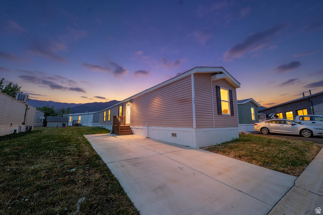 2491 Highway 89, Unit 403 Pleasant View, UT 84404 - Photo 2 of 32 Home exterior featuring horizontal siding, a private concrete driveway, and a white foundation skirting