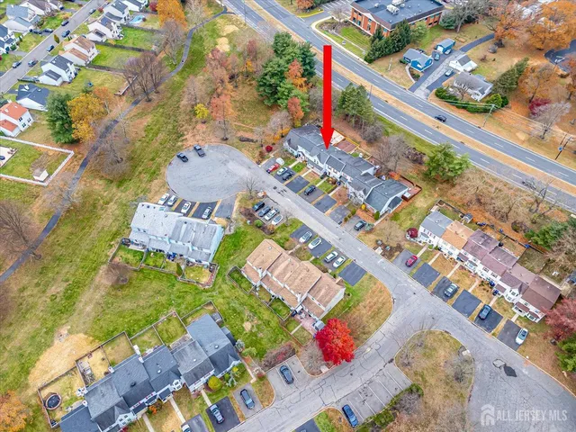 a view of multiple houses with a big yard
