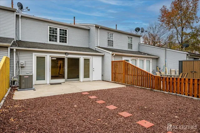 a front view of building with an outdoor space and seating