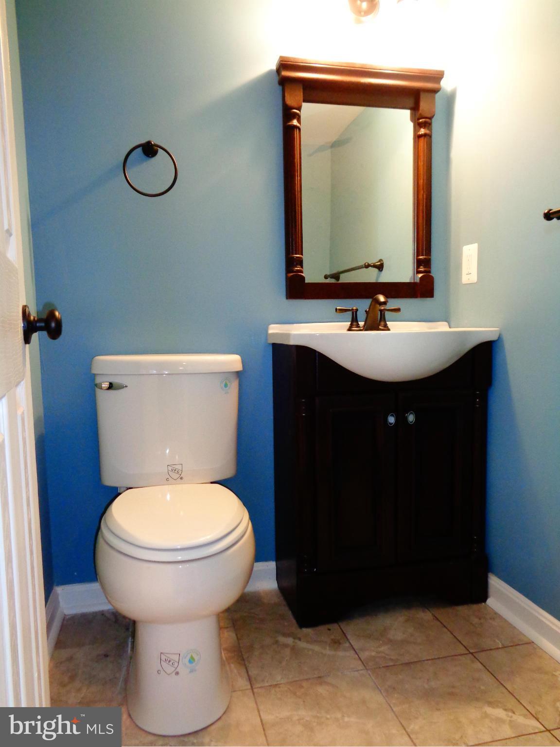 2109 Hawthorne Road Baltimore, MD 21220 - Photo 13 of 28 a bathroom with a toilet sink and mirror