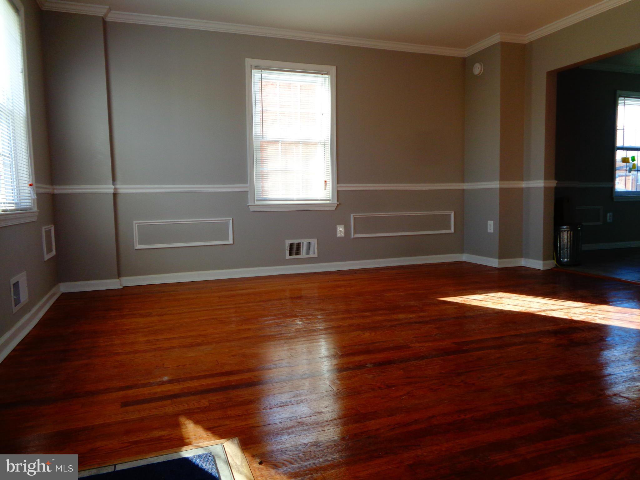 2109 Hawthorne Road Baltimore, MD 21220 - Photo 3 of 28 a view of empty room with wooden floor and fan