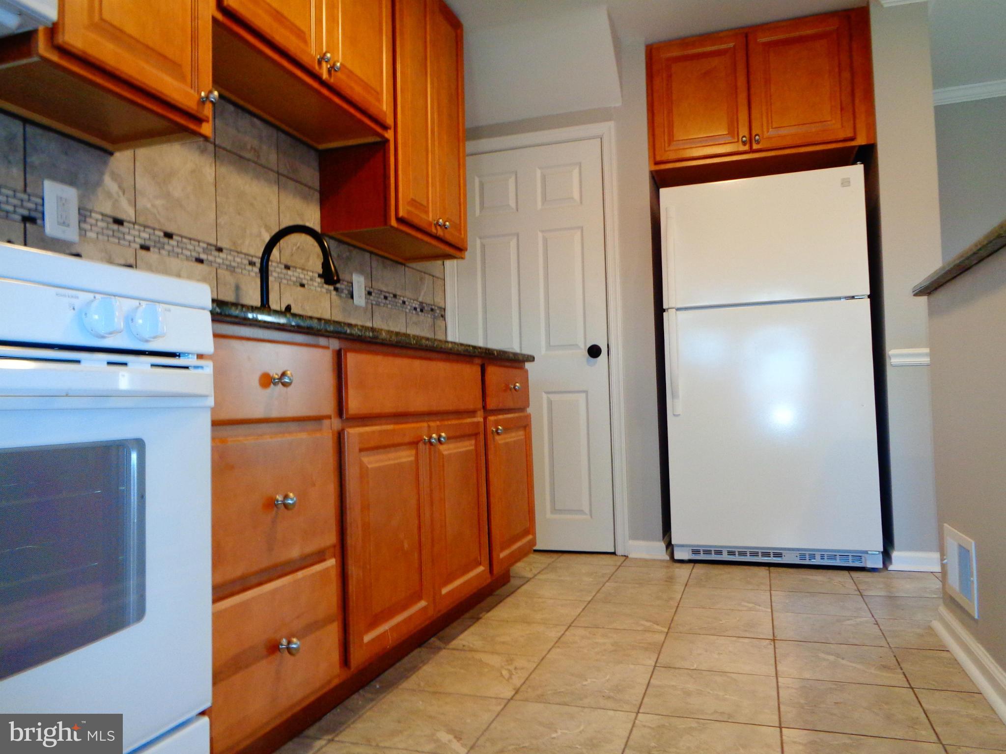 2109 Hawthorne Road Baltimore, MD 21220 - Photo 7 of 28 a view of a storage and utility room with washer and dryer