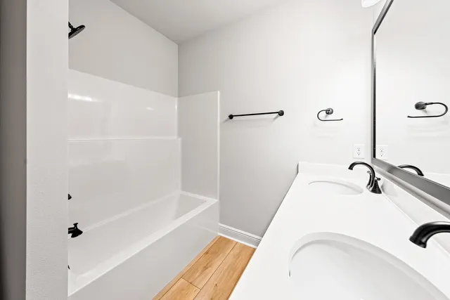 a bathroom with a tub sink and vanity