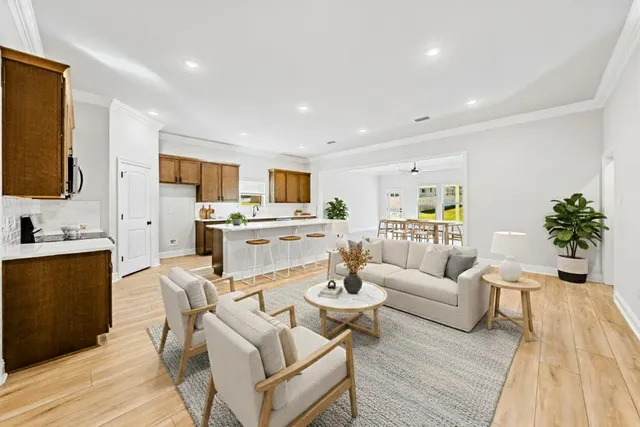 a living room with furniture and a flat screen tv
