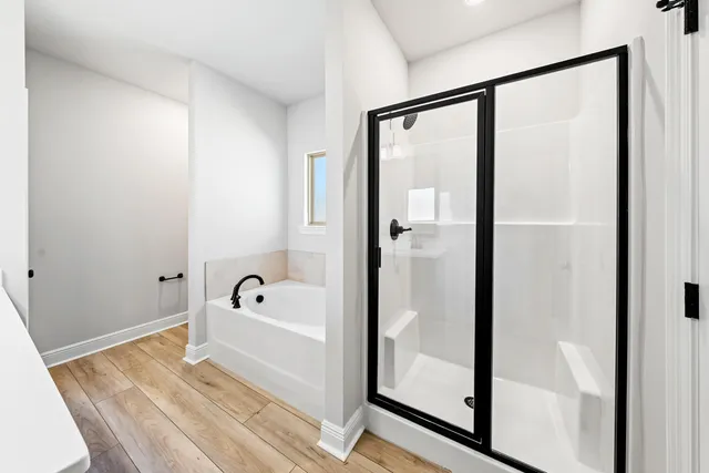 a bathroom with a bathtub and a shower