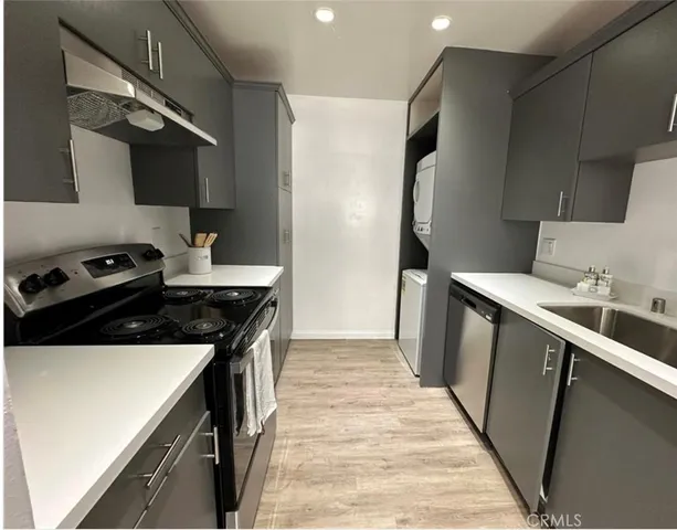 a kitchen with a sink stove and refrigerator