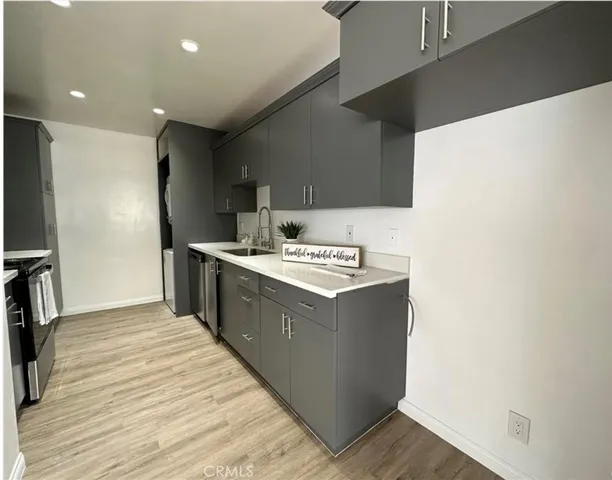 a kitchen with stainless steel appliances granite countertop a sink and a refrigerator