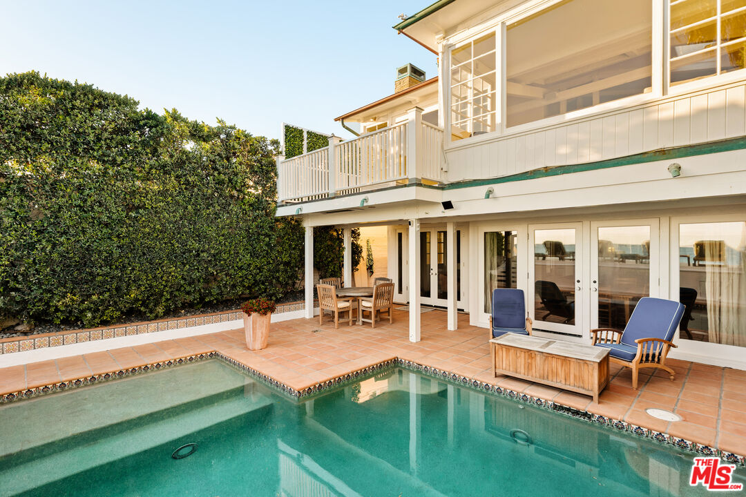 23422 Malibu Colony Road, Unit 98 Malibu, CA 90265 - Photo 23 of 42 a view of a house with swimming pool and sitting area