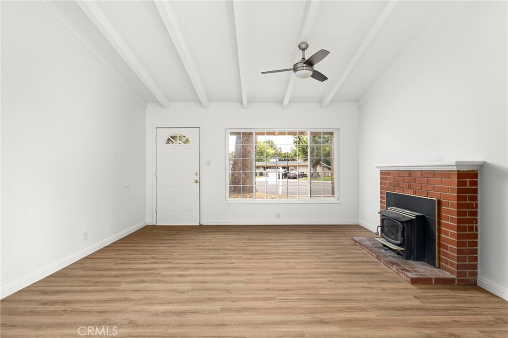 2344 Porter Way Chico, CA 95926 - Photo 12 of 35 an empty room with windows fireplace and wooden floor