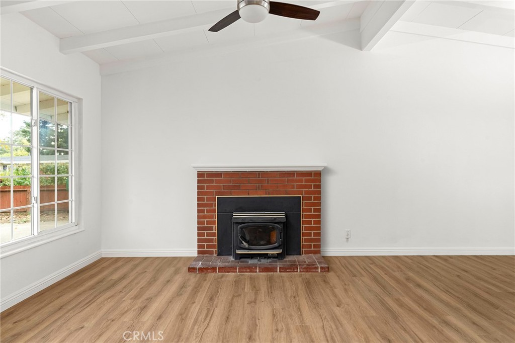 2344 Porter Way Chico, CA 95926 - Photo 13 of 35 a view of an empty room with wooden floor fireplace and a window