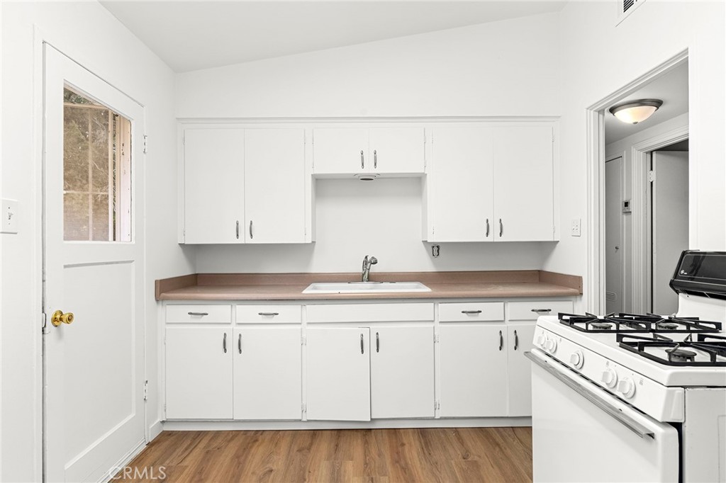 2344 Porter Way Chico, CA 95926 - Photo 16 of 35 a kitchen with granite countertop a sink stove and cabinets