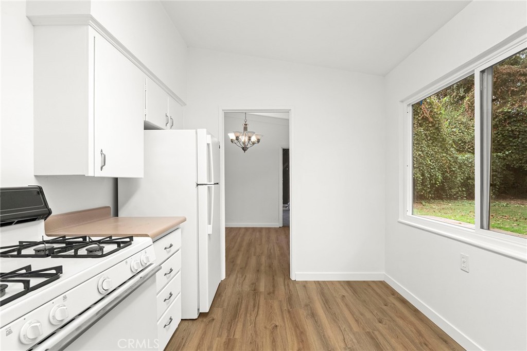 2344 Porter Way Chico, CA 95926 - Photo 17 of 35 a kitchen with a stove a refrigerator and a wooden floor