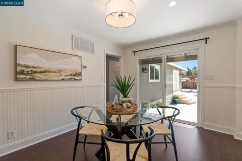 a kitchen with granite countertop white cabinets and window