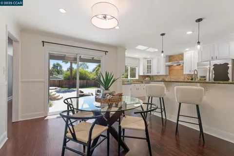 a kitchen with granite countertop stainless steel appliances a stove sink and window