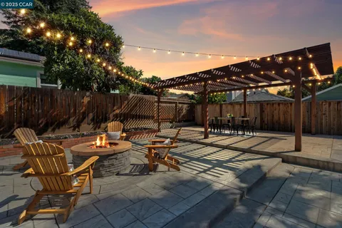 a view of backyard with swimming pool and furniture