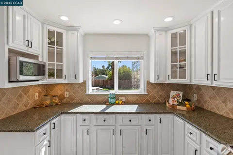 a view of a refrigerator and an empty room in a hall