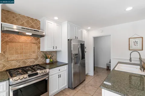a bedroom with furniture and a large window