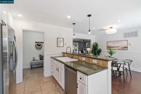 a bedroom with a large bed and wooden floor