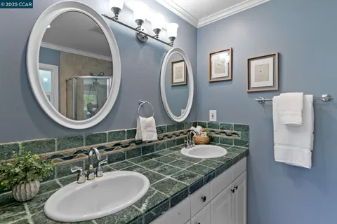 a view of patio with couches a fire pit and wooden fence