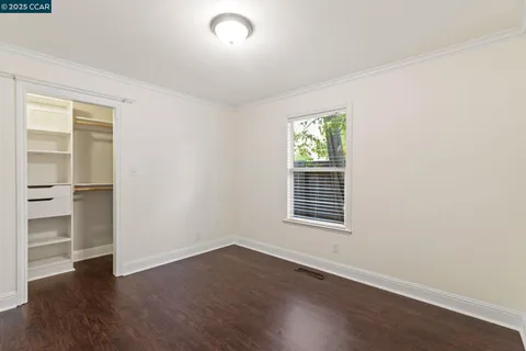 a view of a patio with couches and a table and chairs with wooden fence