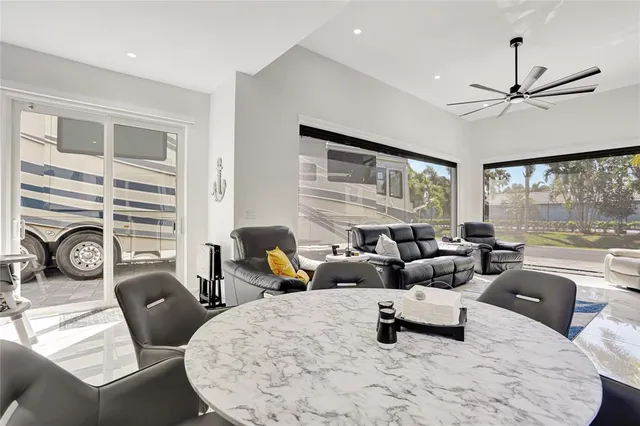 a living room with furniture large window and flat screen tv