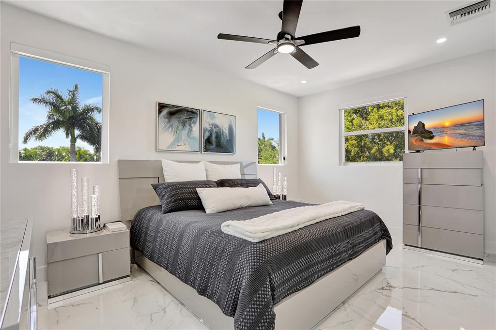 359 Sundial Circle, Unit 359 Margate, FL 33068 - Photo 18 of 36 a bedroom with a bed and a painting on the wall
