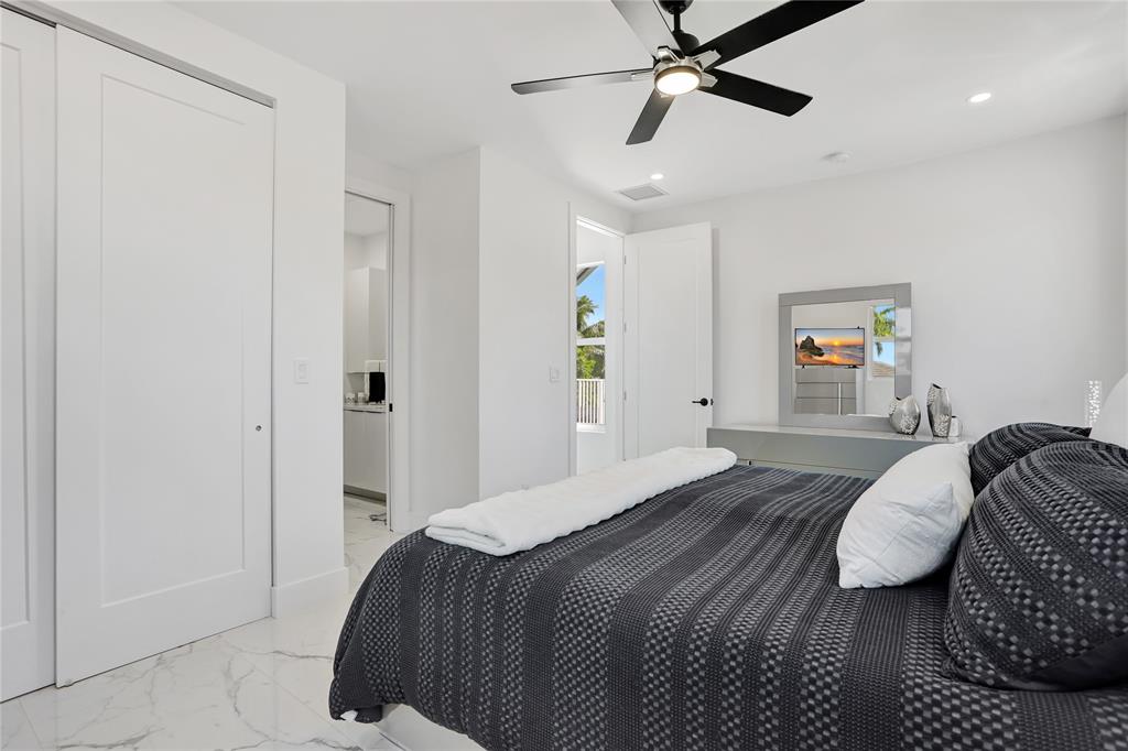 359 Sundial Circle, Unit 359 Margate, FL 33068 - Photo 19 of 36 a bedroom with a bed and ceiling fan
