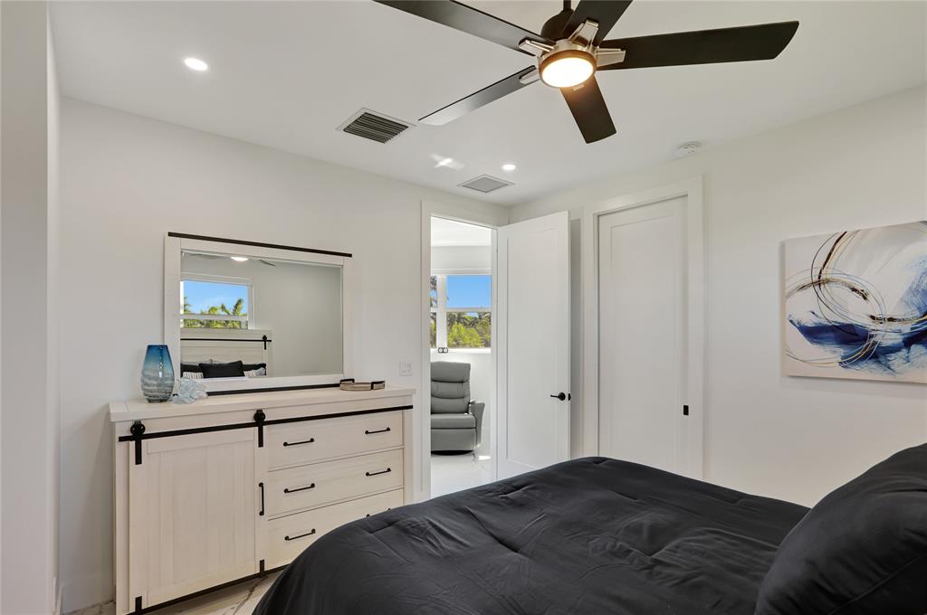 359 Sundial Circle, Unit 359 Margate, FL 33068 - Photo 24 of 36 a bedroom with a bed and a chandelier