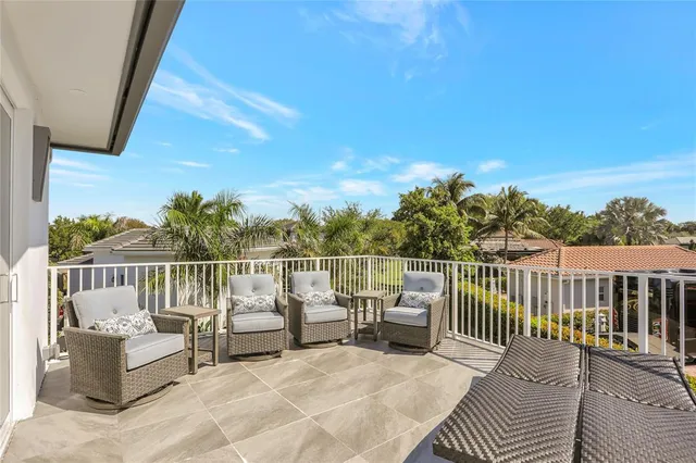 a balcony with furniture and a garden