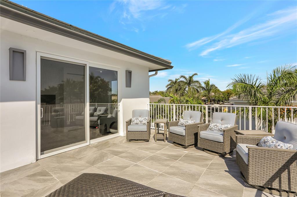 359 Sundial Circle, Unit 359 Margate, FL 33068 - Photo 26 of 36 a balcony with furniture and a garden