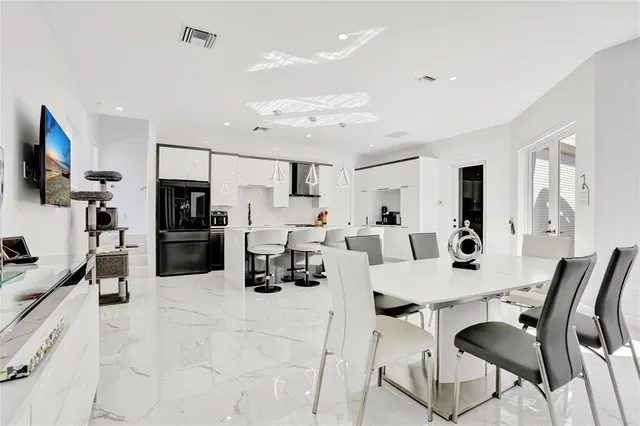 a large kitchen with a table and chairs